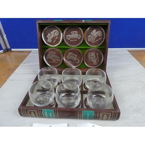 970 - A boxed set of six 'Veteran Cars' toasting glasses and leather coasters - By Appointment to the Roya... 