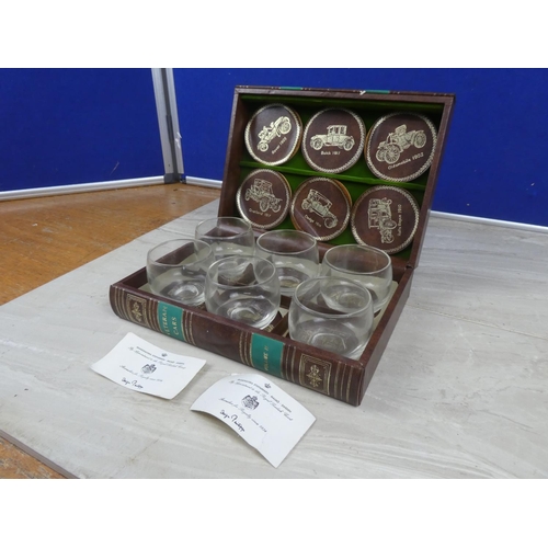 970 - A boxed set of six 'Veteran Cars' toasting glasses and leather coasters - By Appointment to the Roya... 