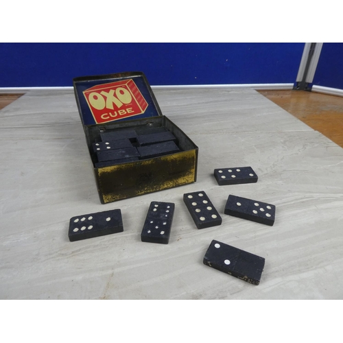 975 - A vintage OXO tin and a lot of vintage train patterned dominoes.