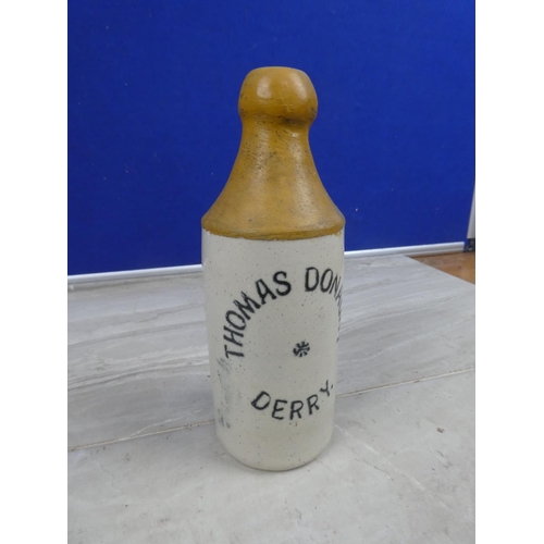 995 - An antique Thomas Donaghy, Derry stoneware beer bottle with repair.