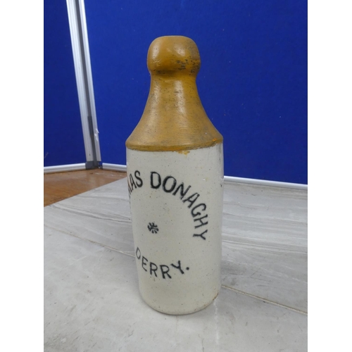 995 - An antique Thomas Donaghy, Derry stoneware beer bottle with repair.