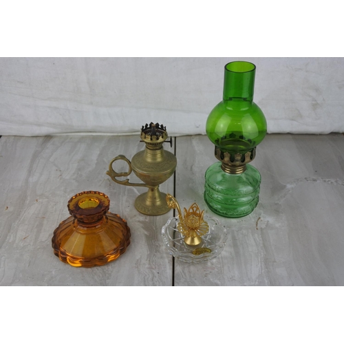 1021 - A small vintage green glass oil lamp and three others.