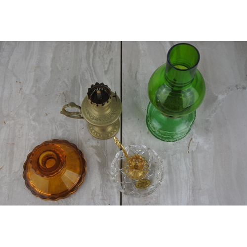 1021 - A small vintage green glass oil lamp and three others.