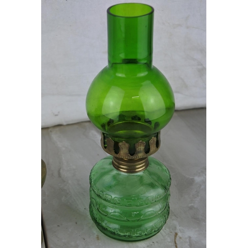 1021 - A small vintage green glass oil lamp and three others.