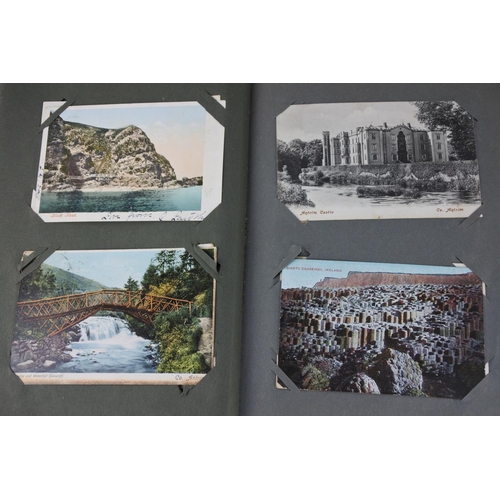 1028 - A vintage postcard album containing postcards from Belfast, Giant's Causeway, Dublin, comical postca... 