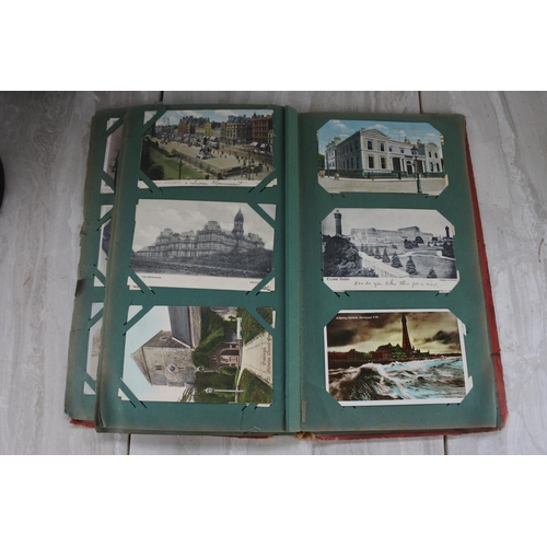 1082 - A vintage postcard albums containing postcards of warships, London Bridge, comical postcards and lot... 