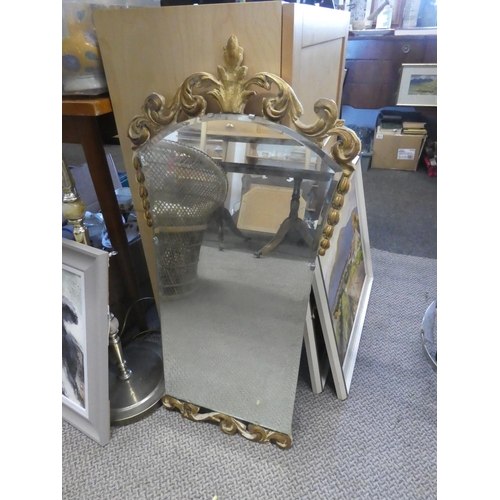 608 - A stunning gilt framed wall mirror with scroll detail. Approx 45x85CM.