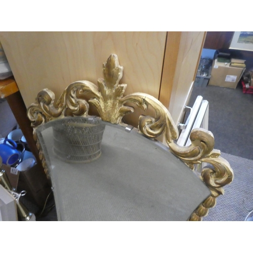 608 - A stunning gilt framed wall mirror with scroll detail. Approx 45x85CM.