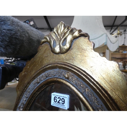 629 - A stunning oval slim and gilt framed wall mirror, measuring  Approx 39x115cm.