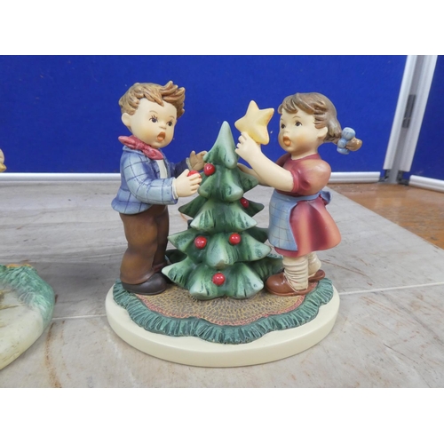 667 - Two Hummel figurines 'All in Together' and 'Christmas Fun'.