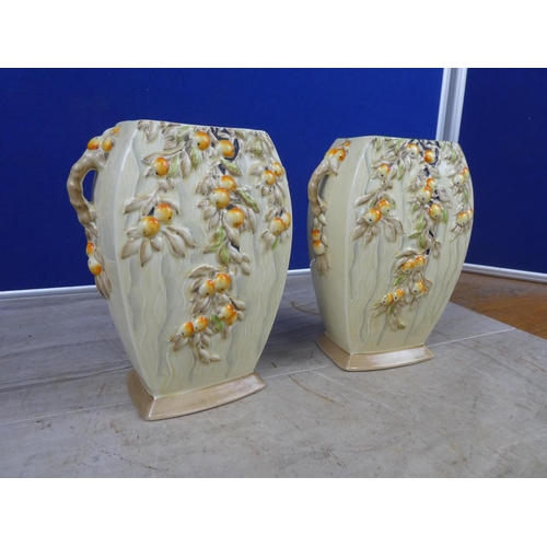 673 - A pair of stunning art deco Myott & Son hand painted vases decorated with fruit.  Approx 21cm.