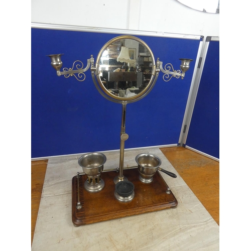 679 - A Campaign shaving mirror on an oak stand.  Approx 38x53x23cm.