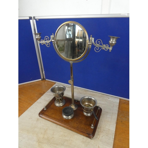 679 - A Campaign shaving mirror on an oak stand.  Approx 38x53x23cm.