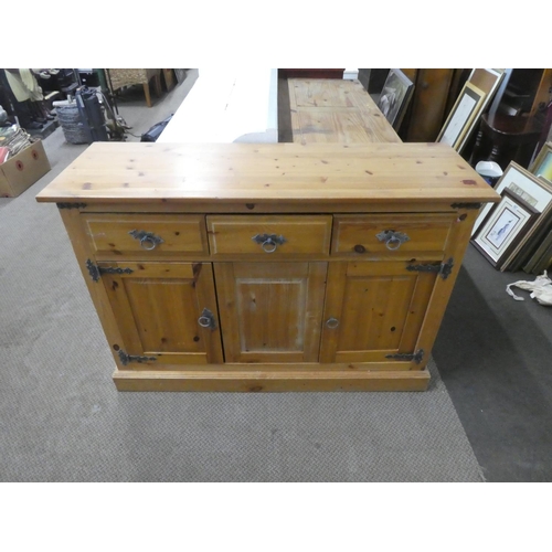 682 - A pine three door sideboard.  Approx 118x82x40cm.