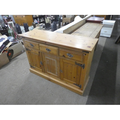 682 - A pine three door sideboard.  Approx 118x82x40cm.