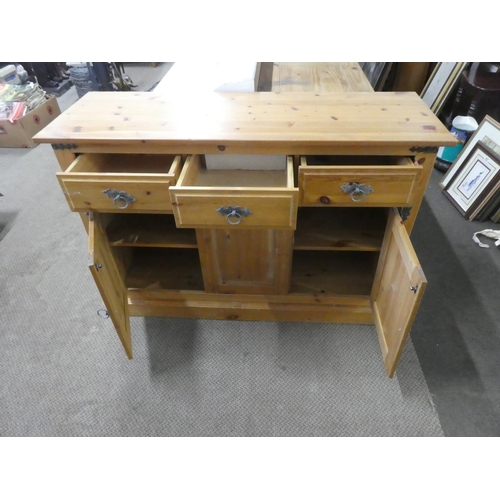 682 - A pine three door sideboard.  Approx 118x82x40cm.