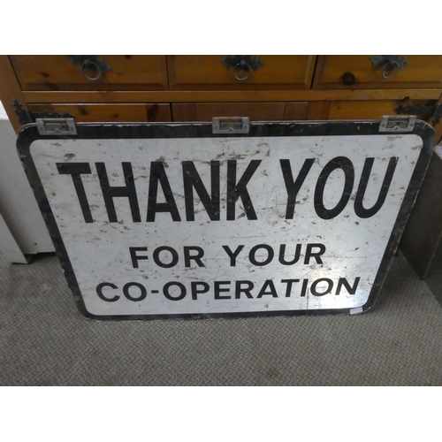 683 - A double sided road sign 'Stop Checkpoint Headlights Off' and 'Thank you for Your Co-Operation'.  Ap... 