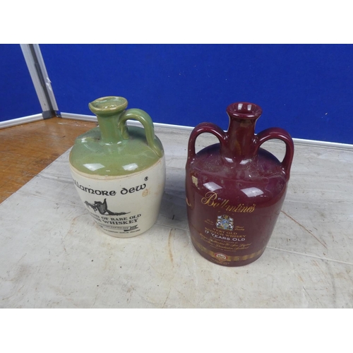 686 - A 'Tullamore Dew' stoneware whiskey flagon and a Wade 'Ballentines' ceramic whiskey flagon.