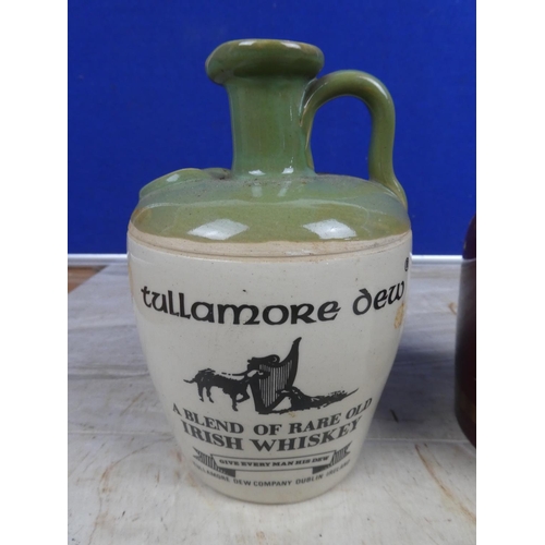 686 - A 'Tullamore Dew' stoneware whiskey flagon and a Wade 'Ballentines' ceramic whiskey flagon.