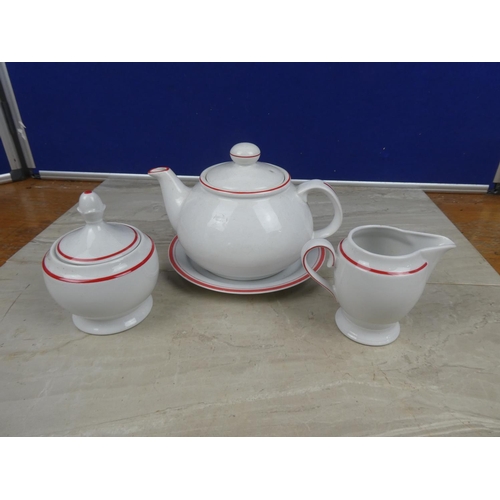 1120 - A German pottery teapot, milk jug, sugar bowl and plate.