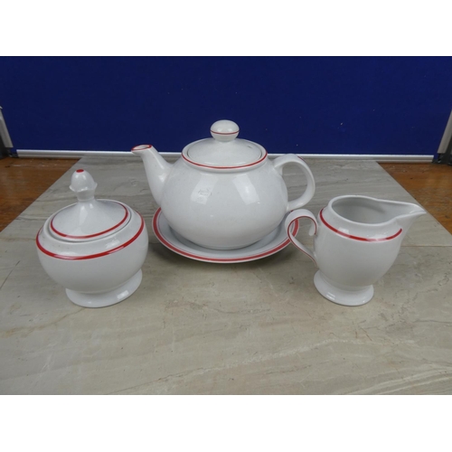 1120 - A German pottery teapot, milk jug, sugar bowl and plate.