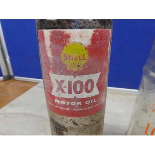 1128 - A vintage Shell X100 motor oil bottle (a/f) and a vintage Lobitos motor oil bottle.