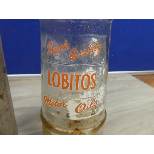 1128 - A vintage Shell X100 motor oil bottle (a/f) and a vintage Lobitos motor oil bottle.