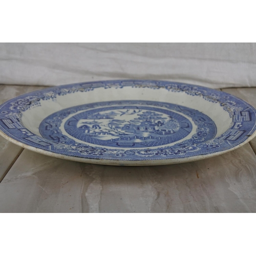 72 - A large antique Indian Tree patterned blue and white charger.  Approx 38cm dia.