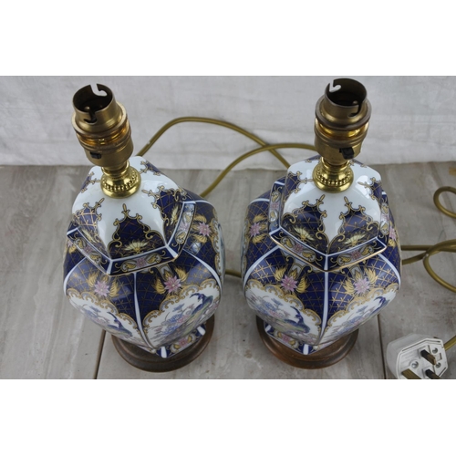 358 - A pair of ceramic and wood table lamp bases. Approx 34cm.