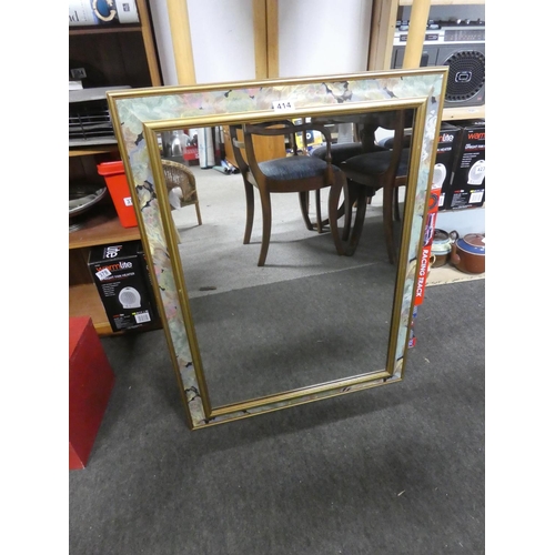 414 - A floral patterned framed mirror. Approx 64x84cm.