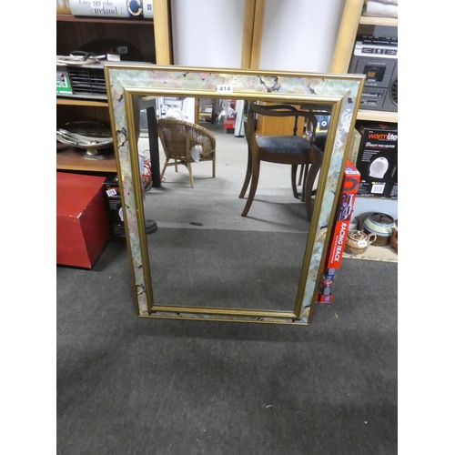 414 - A floral patterned framed mirror. Approx 64x84cm.