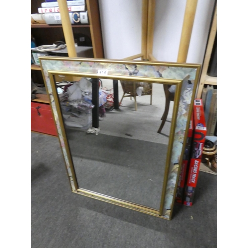 414 - A floral patterned framed mirror. Approx 64x84cm.