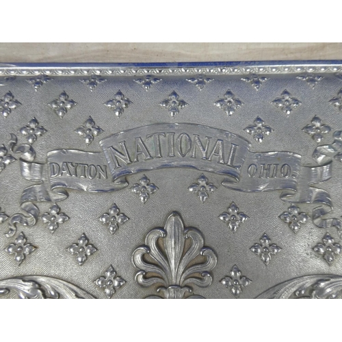 426 - A decorative metal panel from an antique National Dayton OH10 cash register. Approx 47x25cm.