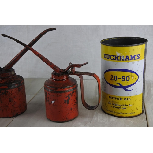 16 - A vintage Duckham's motor oil can, two vintage oil cans and another.