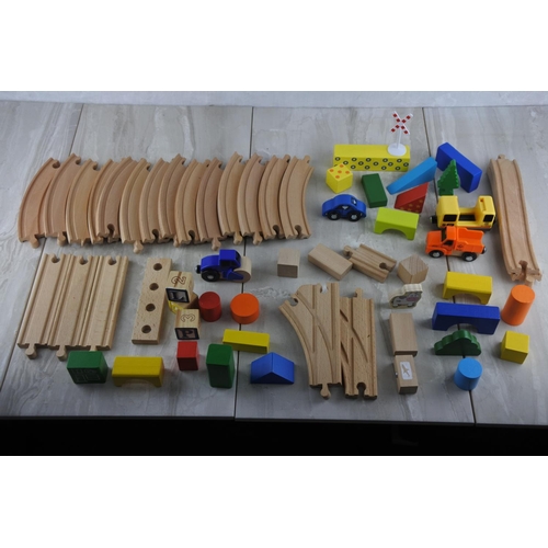 3 - An assortment of wooden train tracks and and a lot of toy vehicles.