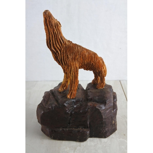 51 - A hand carved wooden figure of a wolf, by local Artist, Bobby Fisher. Approx 25cm.