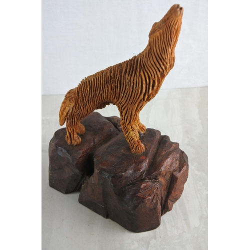 51 - A hand carved wooden figure of a wolf, by local Artist, Bobby Fisher. Approx 25cm.