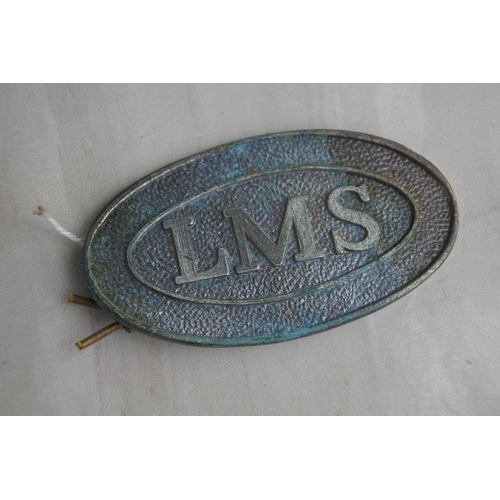 57 - A vintage LMS railway cap badge.