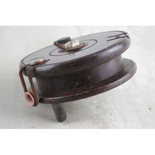 60 - An antique Bakelite fishing reel.