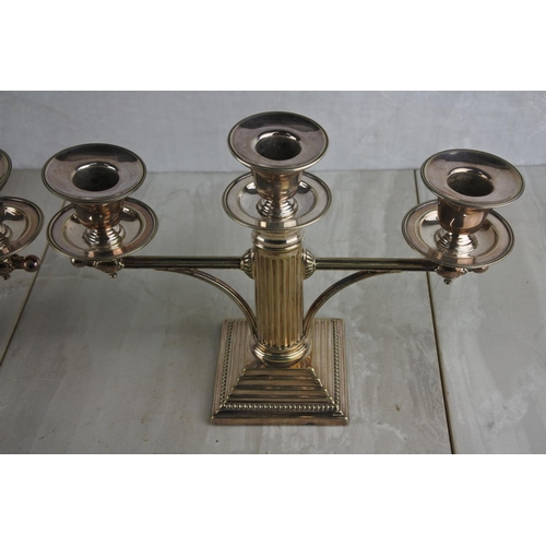 63 - A stunning pair of silver plated, Corinthian column three branch candlesticks. Approx 18x26cm.