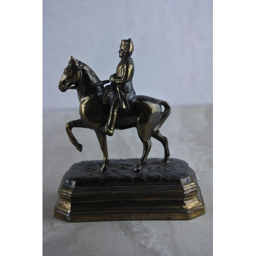 64 - A vintage metal figure, modelled as Napoleon on horse, embossed G.R. France. Approx 12cm.