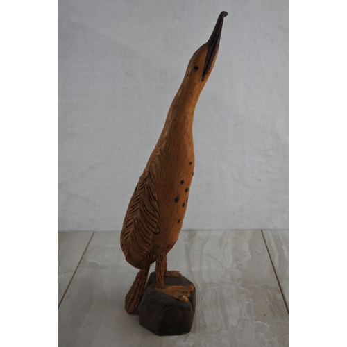 69 - A wooden hand carved figure of a bird, by local Artist, Bobby Fisher. Approx 37cm.