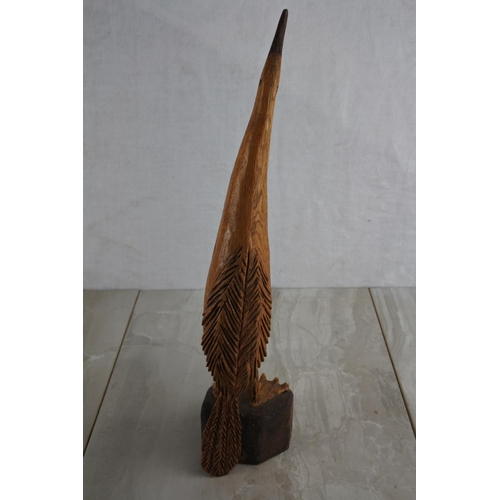 69 - A wooden hand carved figure of a bird, by local Artist, Bobby Fisher. Approx 37cm.