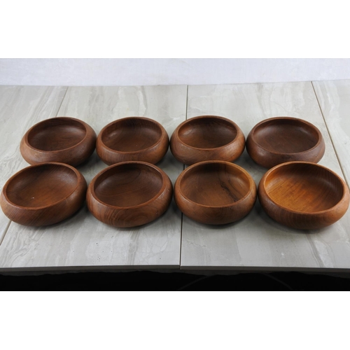 77 - Eight vintage teak bowls.