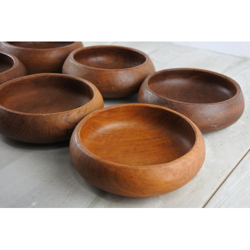 77 - Eight vintage teak bowls.