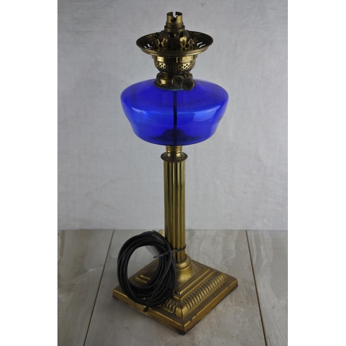 78 - A stunning antique brass oil lamp with blue glass font. (Electric conversion) Approx 52cm.