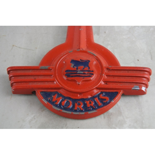 82 - A vintage Morris Minor hood badge. Approx 17x11cm.