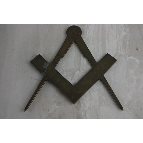 89 - An antique brass Masonic symbol.