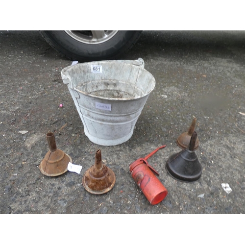 681 - A small vintage bucket and a lot of vintage oil funnels and an oil can.