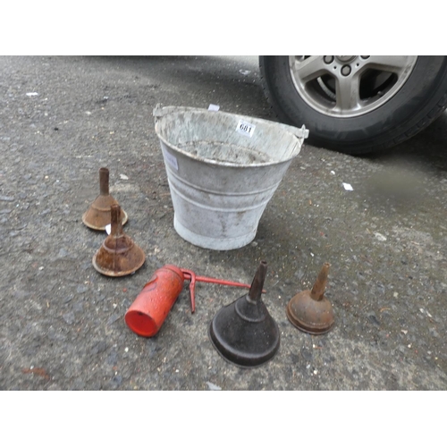 681 - A small vintage bucket and a lot of vintage oil funnels and an oil can.